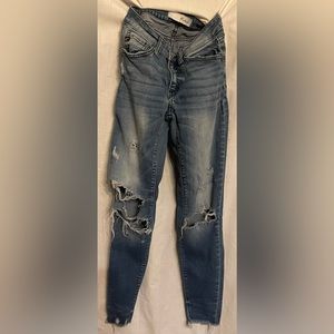 Kancan ripped medium wash skinny jeans.